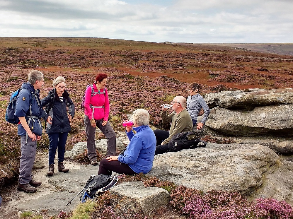 walkers at rocky tor on high moorland